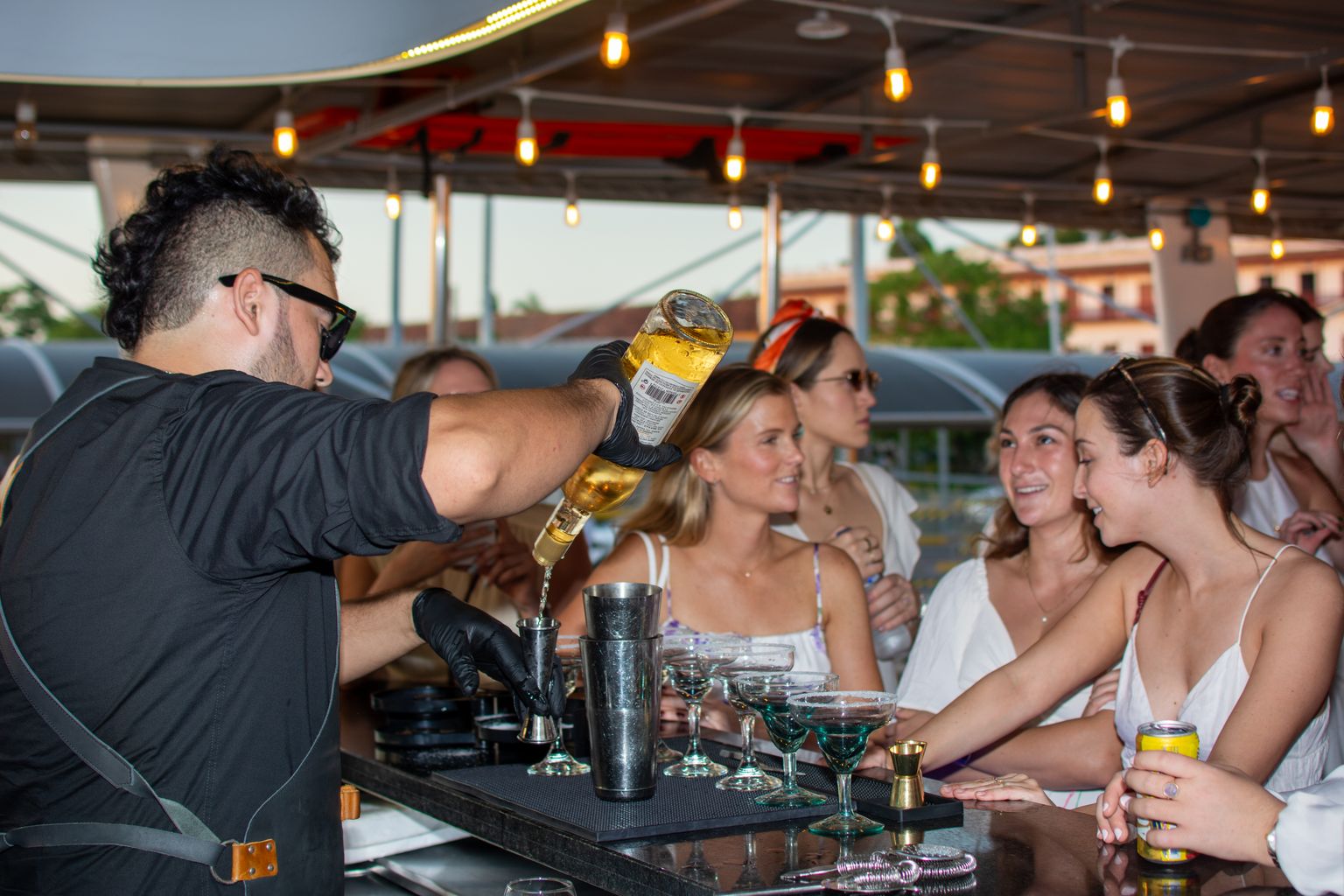 Bartender mixing cocktails, the drinks a cruise drink package calculator adds up